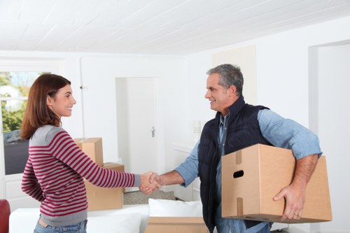 Movers carrying household items through a South Norwood property