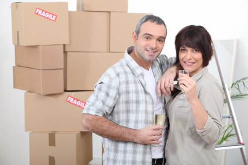 Local movers carrying boxes through a South Norwood flat